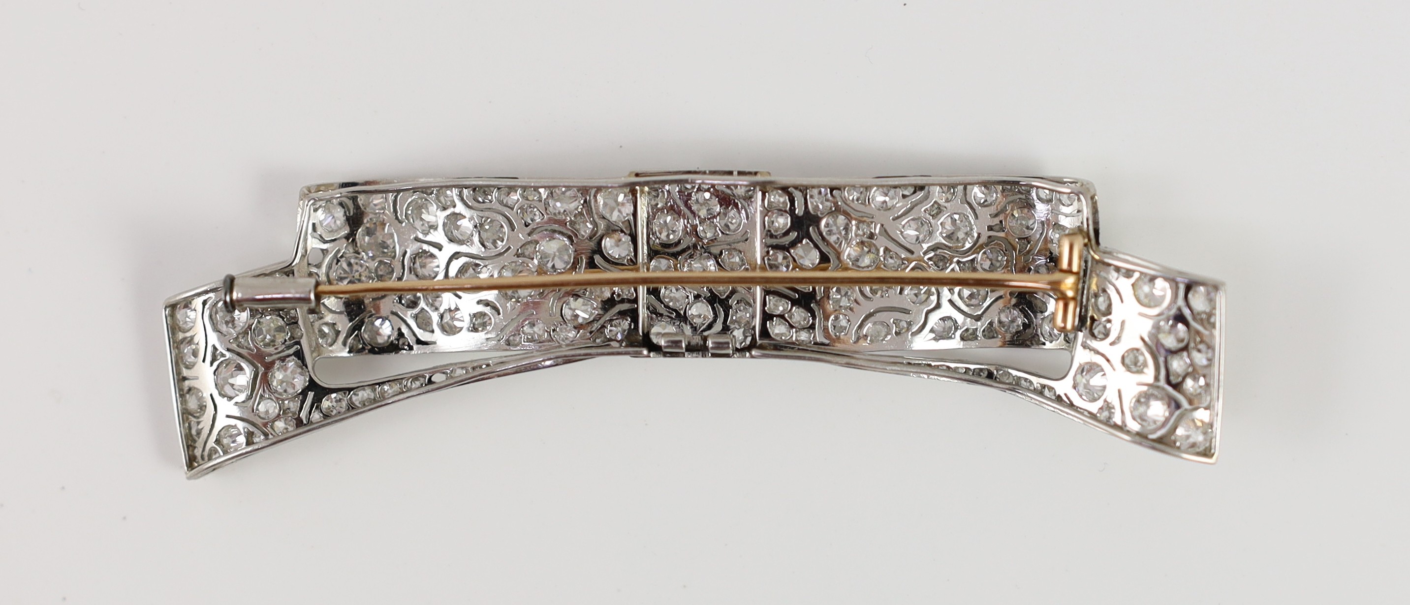 A mid 20th century white gold and pave set diamond ribbon bow brooch